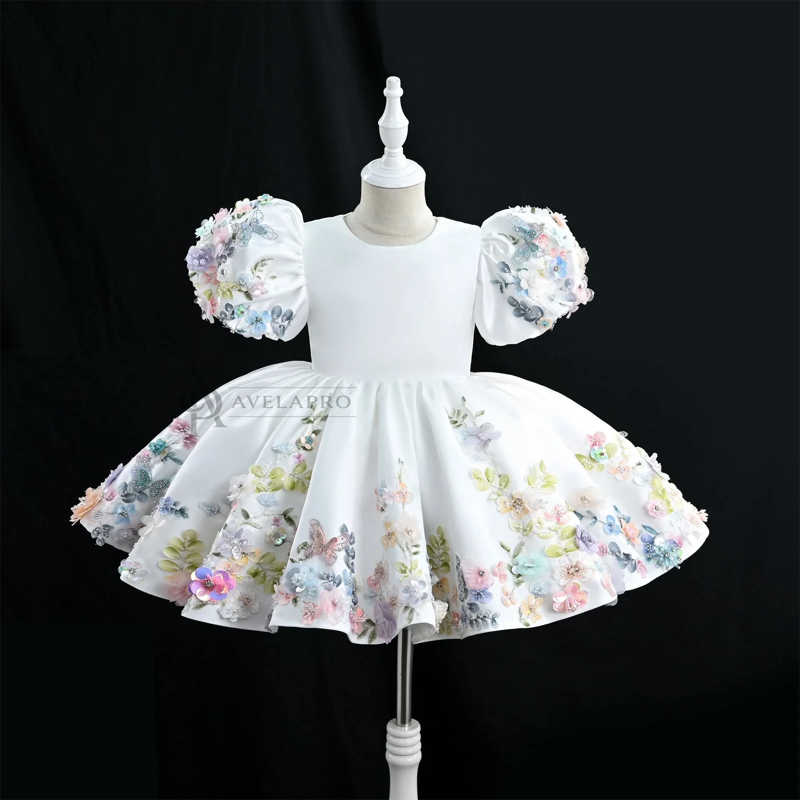 Luxurious white girls' flower girl dress features 3D floral embroidery and puff sleeves.